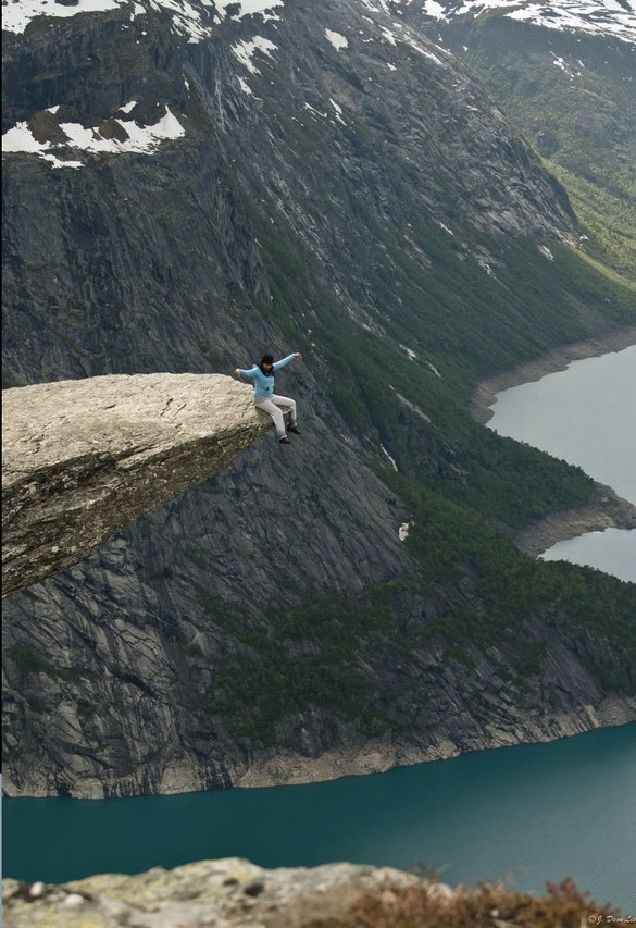 Sitting on the Trolltunga rock in Norway.